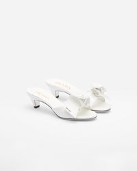 Bianco patent leather heeled mules with prada logo